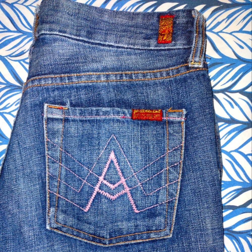 Seven for all man kind size 28/4  has typical wear at the bottom boot cut.